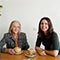 Maurice Blackburn lawyer Sally with her client sitting together by the table with two cups of coffee