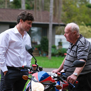Maurice Blackburn lawyer Liam Kelly with his client Graham standing side by side talking.