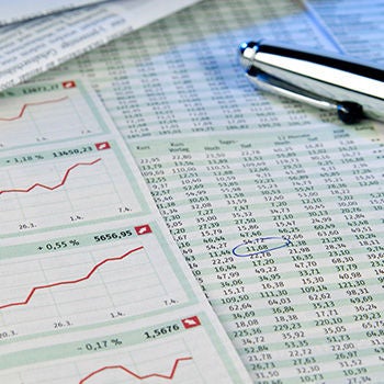Close up of documents with graphs and numbers