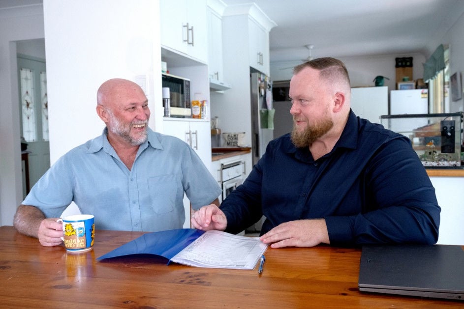 Maurice Blackburn lawyer Michael and his client Vicky sitting by the table, drinking coffee
