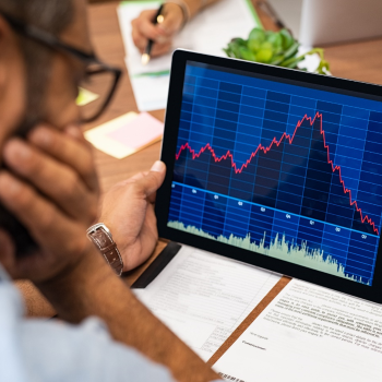 A man looking at a computer screen with a graph on it 