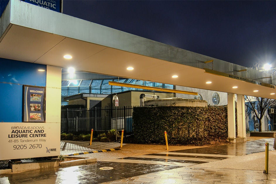 An aquatic and leisure center building at night.