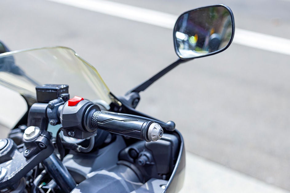 Close-up view of a motorcycle's handlebars.