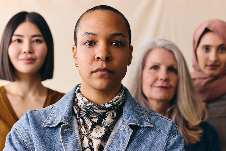 A group of women of various ethnicities standing closely together.