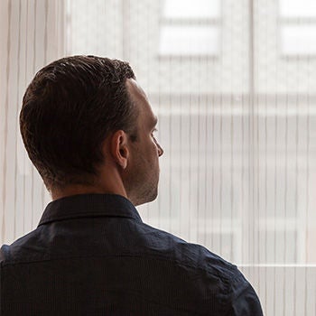 A man staring out of a hotel window