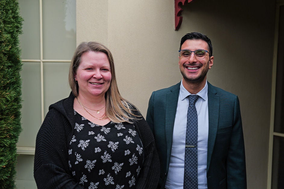 Maurice Blackburn lawyer Ross Sottile and client Rebecca standing side by side similling.