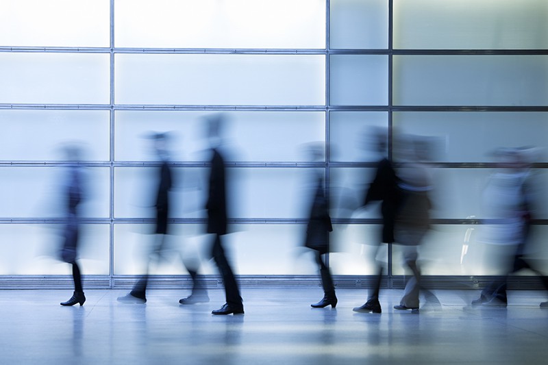 A group of people walking, out of focus