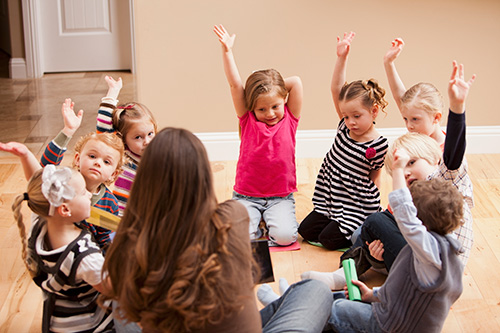 An educator and children at childcare