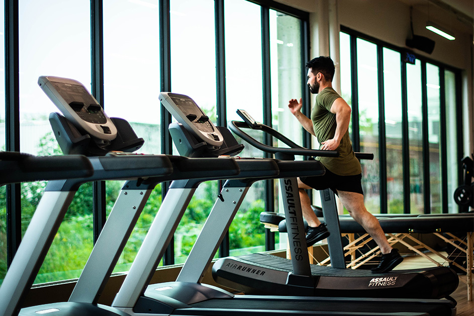 A person running on a treadmill in a gym