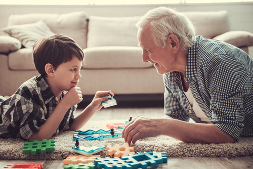 grandfather and grandchild playing in a house