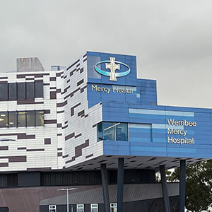The exterior of Werribee Mercy Hospital, showing the Mercy Health signage on the building facade.