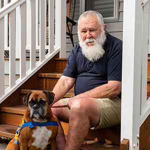 Maurice Blackburn client Jim and his assistance dog Annie by his side.