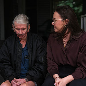 Maurice Blackburn client Robert and lawyer Emily sitting side by side.