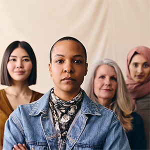 A group of women of various ethnicities standing closely together.