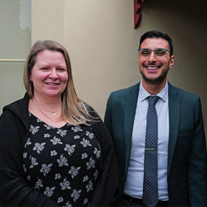 Maurice Blackburn lawyer Ross Sottile and client Rebecca standing side by side similling.