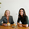 Maurice Blackburn lawyer Sally with her client sitting together by the table with two cups of coffee