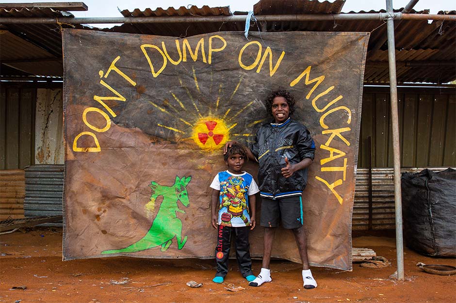 A picture of some Indigenous community members with a sign reading "Don't dump on Muckaty