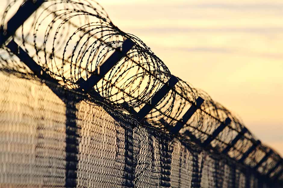 A picture of the barbed wire fence surrounding a detention centre