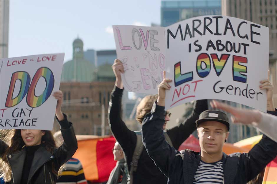 Protestors holding up signs in support of LGBTI equality