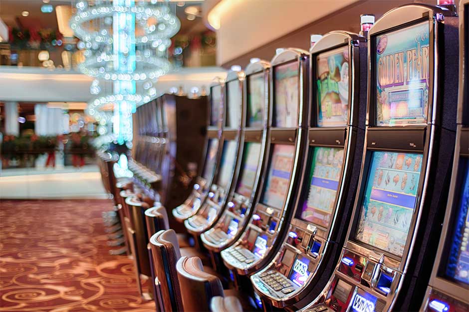 A picture of pokie machines lined up side by side